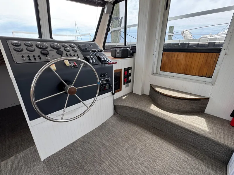 Slide: The Image of Interior helm of 1993 Gibson 37 Sport Series boat with steering wheel and control panel. - 14