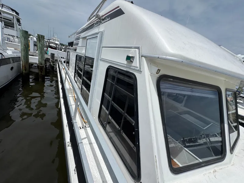 Slide: The Image of 1993 Gibson 37 Sport Series boat docked at marina, side view. - 5