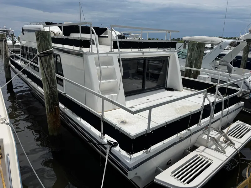 Slide: The Image of 1993 Gibson 37 Sport Series boat docked at marina, featuring spacious deck and modern design. - 6