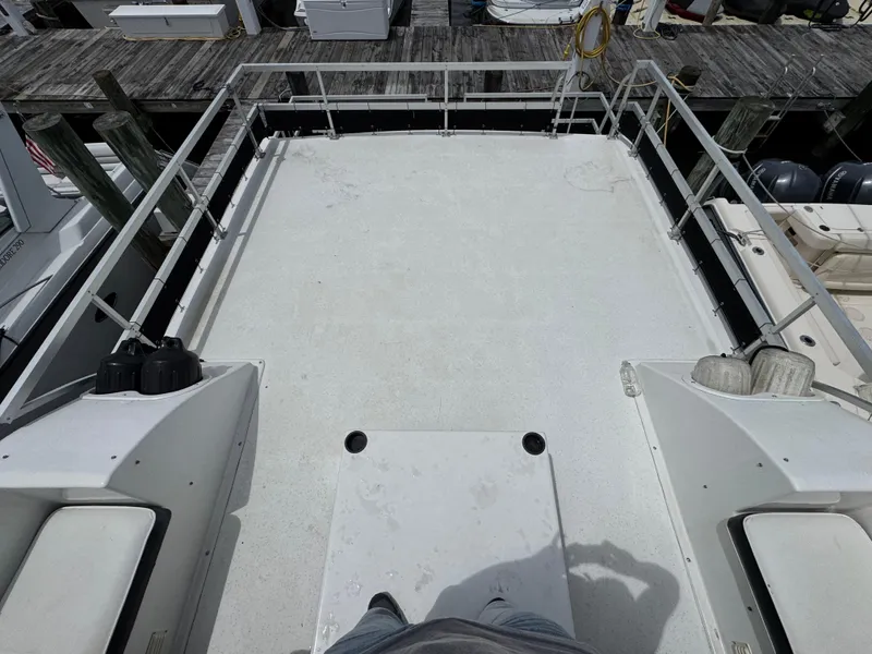 Slide: The Image of Rooftop view of a 1993 Gibson 37 Sport Series boat docked at a marina. - 7