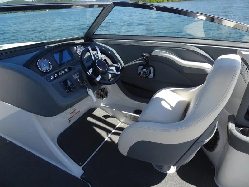 Slide: The Image of 2016 Cobalt R7 boat cockpit with steering wheel and control panel, on a sunny day. - 10