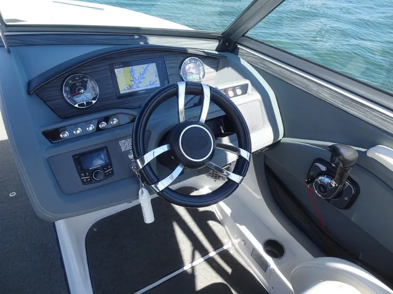 Slide: The Image of 2016 Cobalt R7 boat dashboard with steering wheel and navigation system. - 11