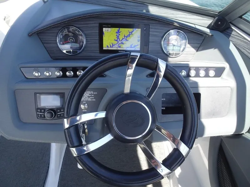 Slide: The Image of Dashboard of a 2016 Cobalt R7 boat with steering wheel and navigation system. - 12