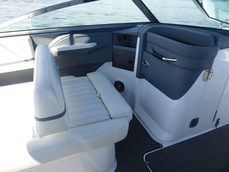 Slide: The Image of 2016 Cobalt R7 boat interior with white seating and sleek dashboard design. - 13