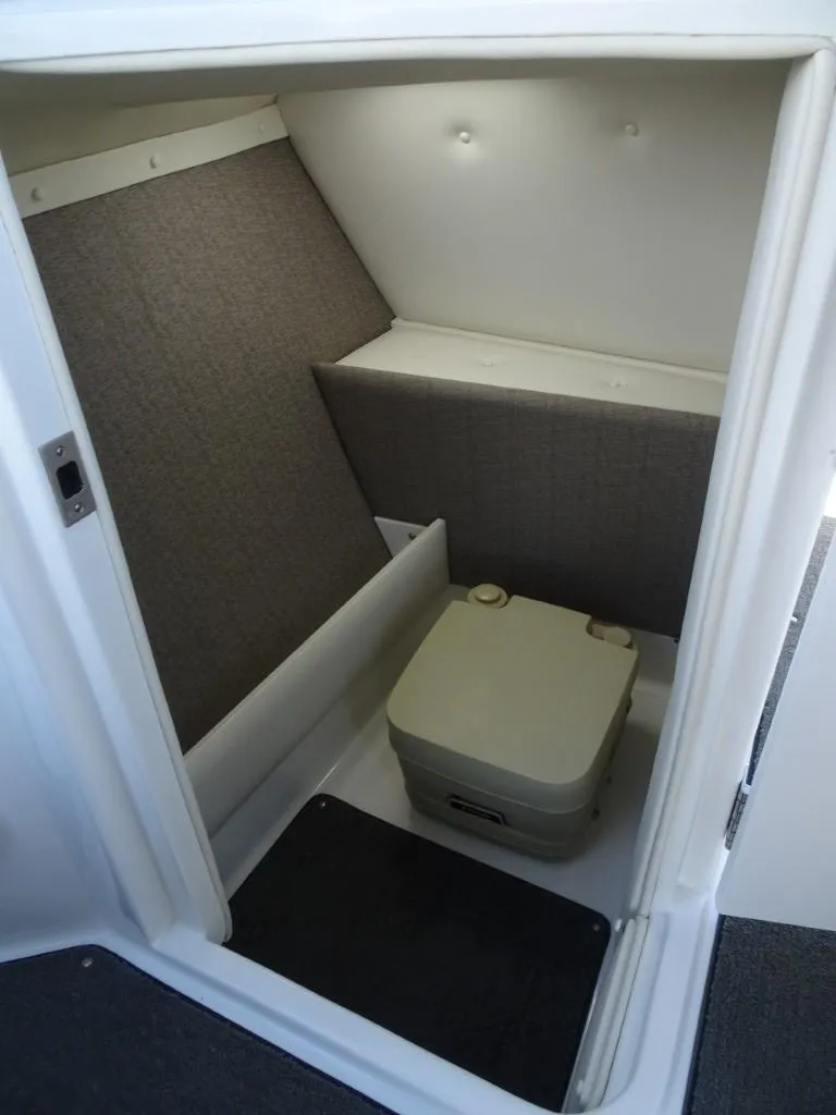 Slide: The Image of 2016 Cobalt R7 boat interior with compact portable toilet. - 14