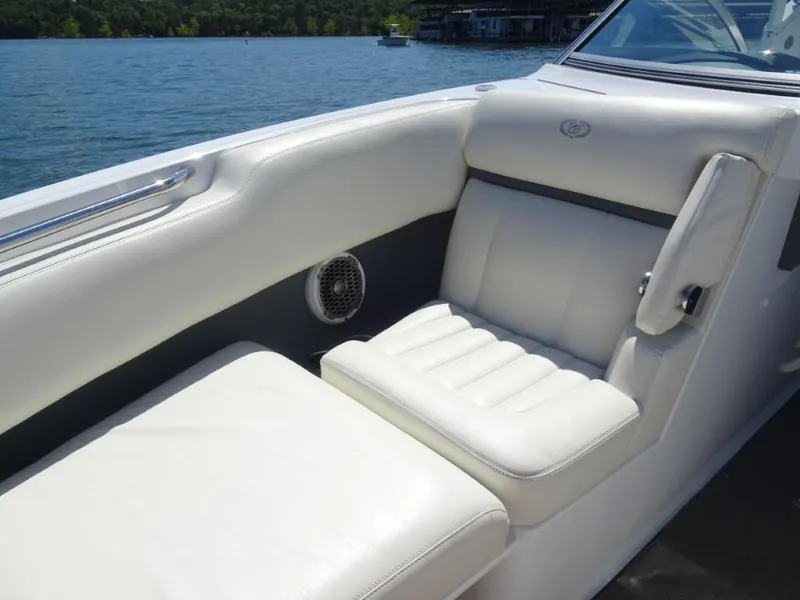 Slide: The Image of Luxurious white seating on 2016 Cobalt R7 boat, with lake view in background. - 16