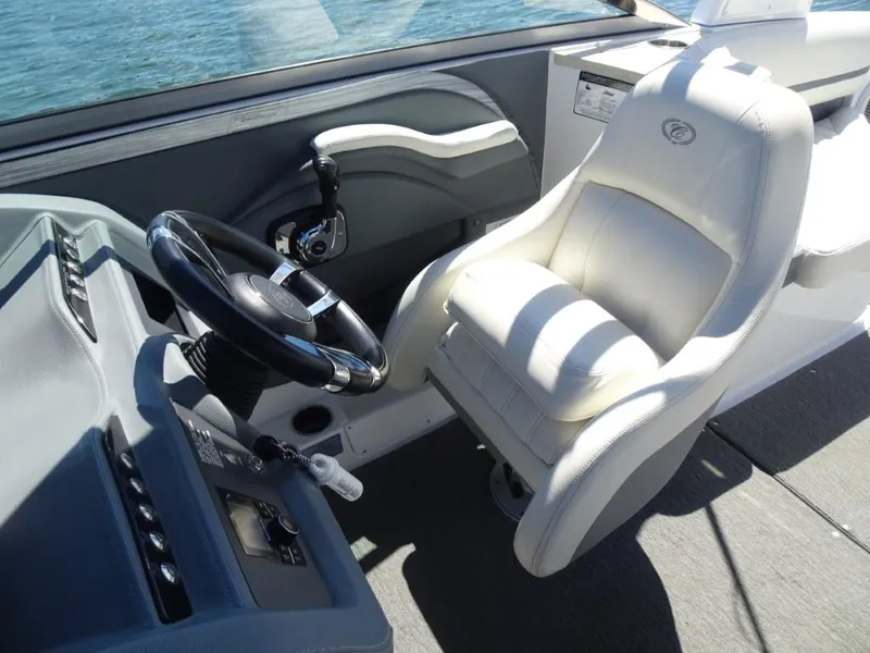 Slide: The Image of 2016 Cobalt R7 boat cockpit with steering wheel and white captain's chair. - 18