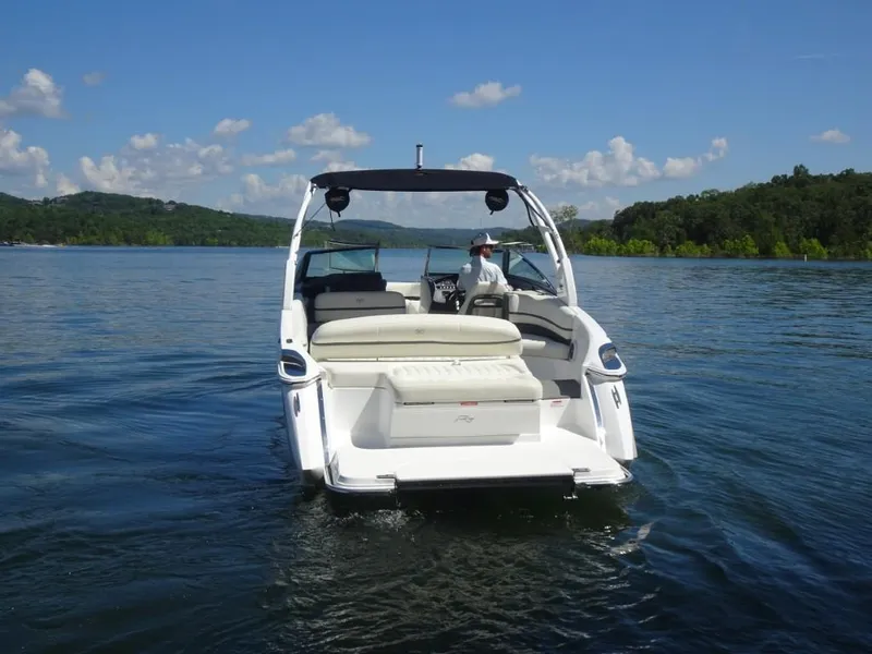 Slide: The Image of 2016 Cobalt R7 boat cruising on a scenic lake under a clear blue sky. - 3