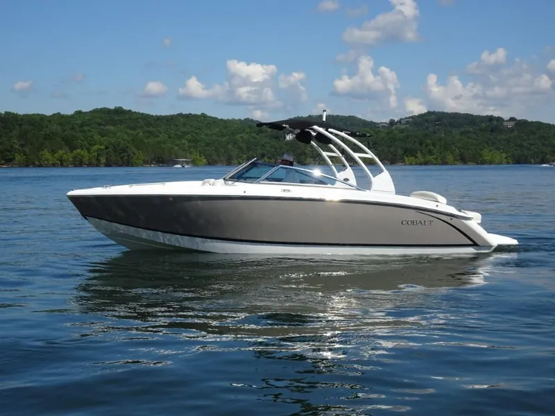 Slide: The Image of 2016 Cobalt R7 boat cruising on a serene lake under a clear blue sky. - 4
