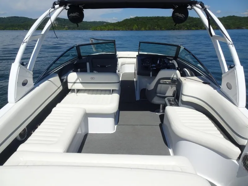 Slide: The Image of 2016 Cobalt R7 boat interior with white seating, on a lake with scenic background. - 6