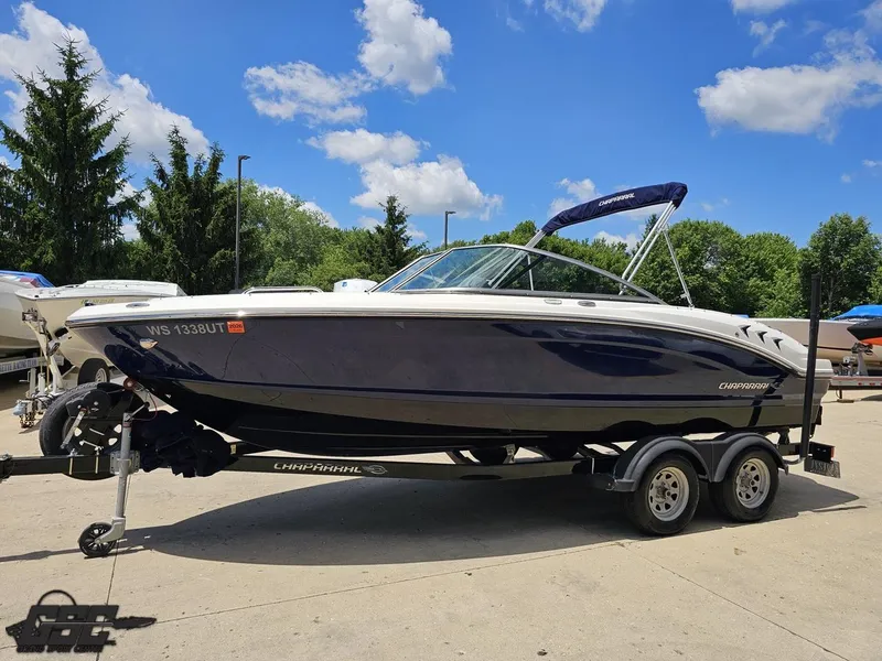 Slide: The Image of 2020 Chaparral 21 SSi boat on trailer under blue sky. - 21