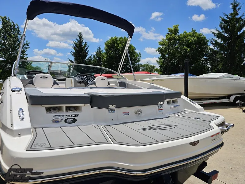 Slide: The Image of 2020 Chaparral 21 SSi boat with seating, docked under a clear blue sky. - 35