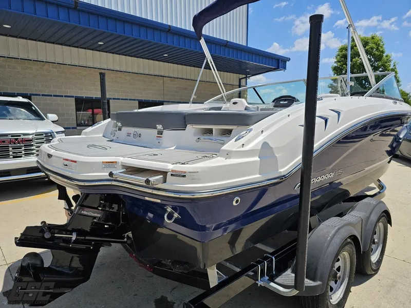 Slide: The Image of 2020 Chaparral 21 SSi boat on trailer, parked outdoors near a building. - 38