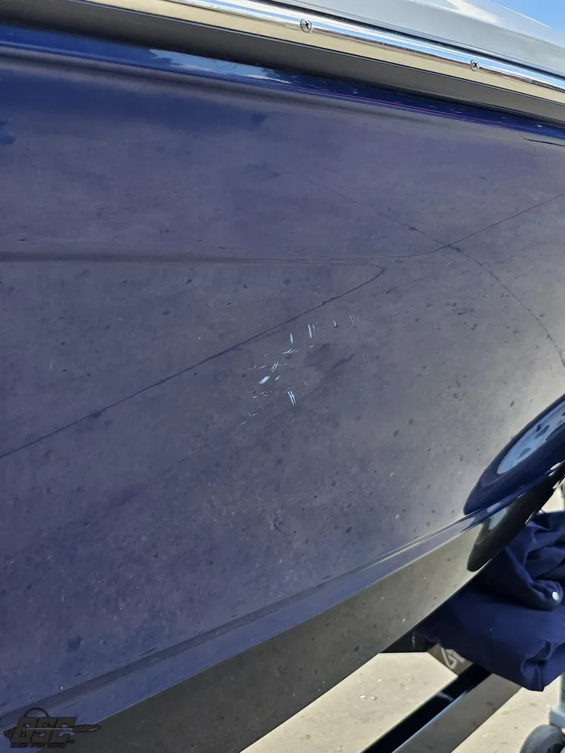 Slide: The Image of 2020 Chaparral 21 SSi boat with visible scratches on the hull. - 41