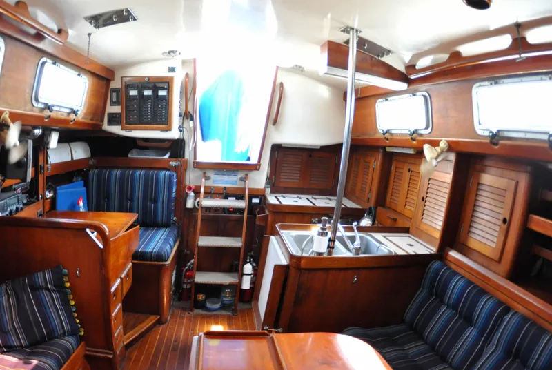 Slide: The Image of Interior of a 1984 Bristol 38.8 sailboat with wood finish and striped upholstery. - 12