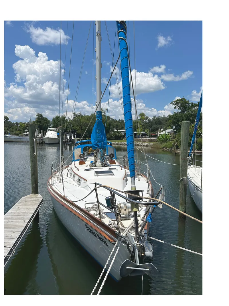 Slide: The Image of 1984 Bristol 38.8 sailboat docked in a marina under a blue sky. - 13