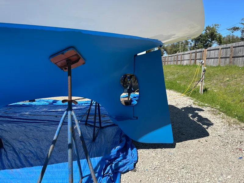 Slide: The Image of 1984 Bristol 38.8 sailboat on stands, blue hull, outdoor setting. - 3