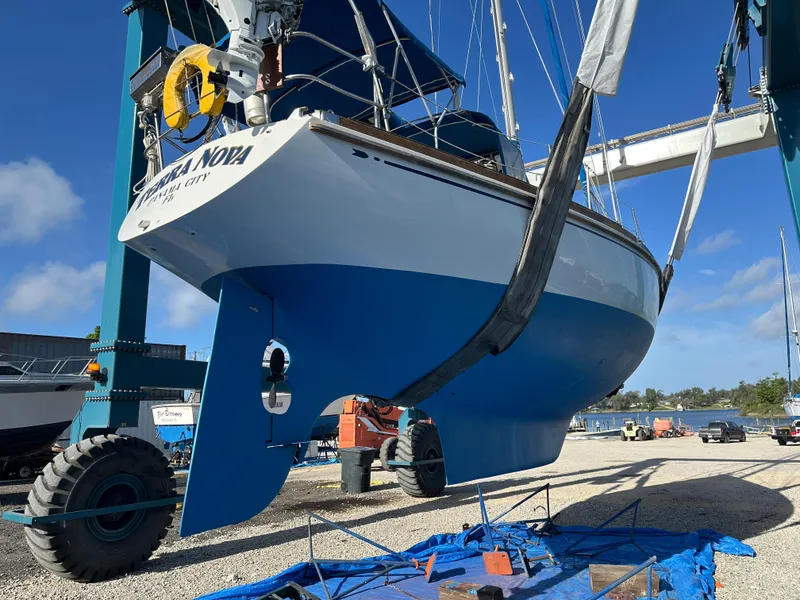 Slide: The Image of 1984 Bristol 38.8 sailboat on a lift, showcasing its blue hull and keel. - 6
