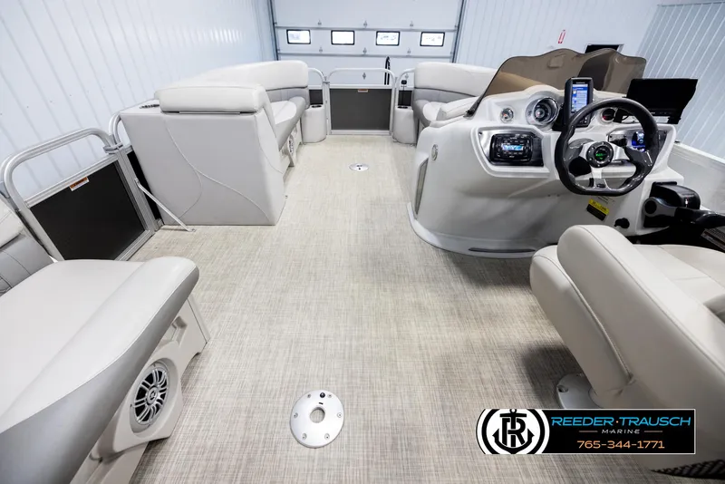 Slide: The Image of 2019 Avalon GS CR pontoon boat interior with beige seating and modern dashboard. - 17