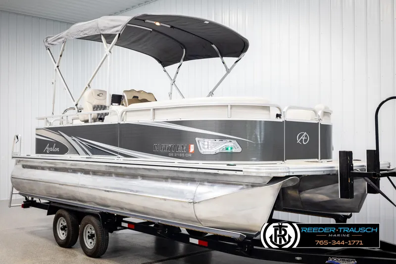 Slide: The Image of 2019 Avalon GS CR pontoon boat with canopy on trailer in showroom. - 3