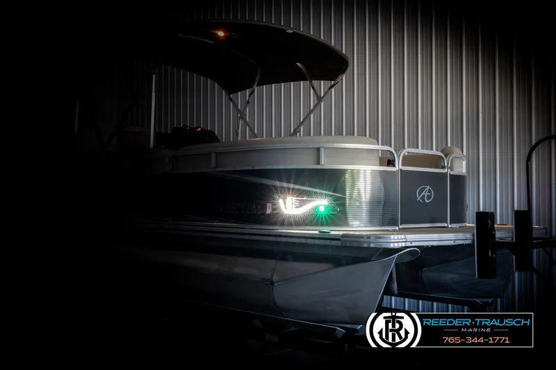 Slide: The Image of 2019 Avalon GS CR pontoon boat in a dimly lit showroom. - 4