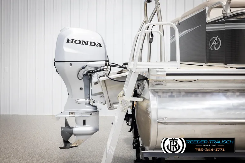 Slide: The Image of 2019 Avalon GS CR pontoon boat with Honda outboard motor, displayed indoors. - 48
