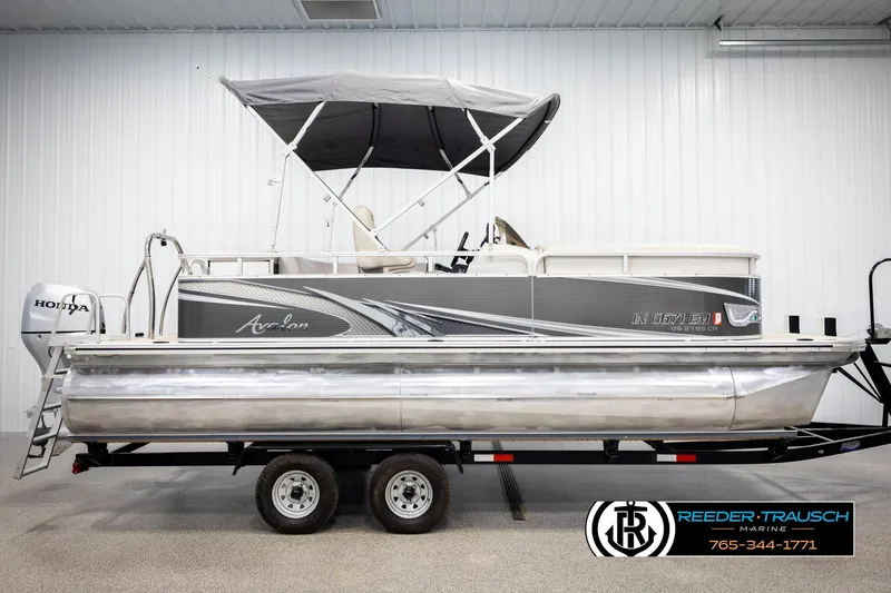 Slide: The Image of 2019 Avalon GS CR pontoon boat on trailer in indoor showroom. - 5