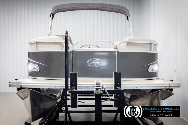 Slide: The Image of 2019 Avalon GS CR pontoon boat in showroom, front view, with Reeder-Trausch Marine logo. - 8