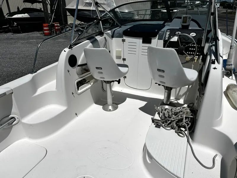 Slide: The Image of Interior of a 1999 Bayliner Trophy boat with dual seats and steering console. - 10