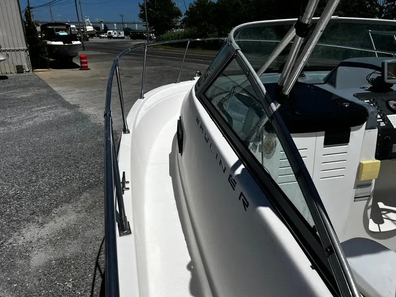 Slide: The Image of Bayliner 2002 Trophy boat, 1999 model, docked in a marina under clear skies. - 12