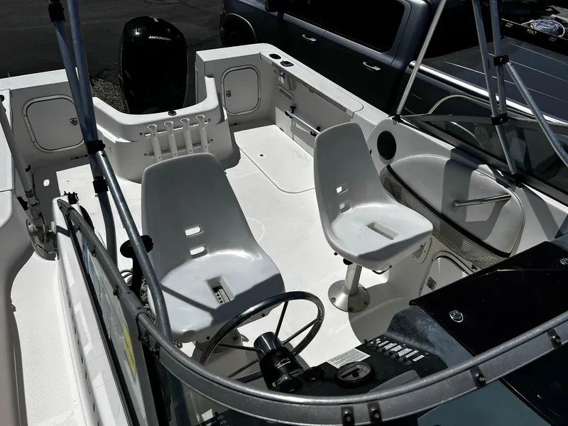 Slide: The Image of Interior of a 1999 Bayliner Trophy boat, featuring seating and control panel. - 16