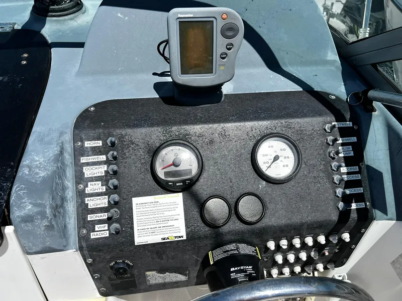 Slide: The Image of Dashboard of a 1999 Bayliner 2002 Trophy boat with gauges and controls. - 17