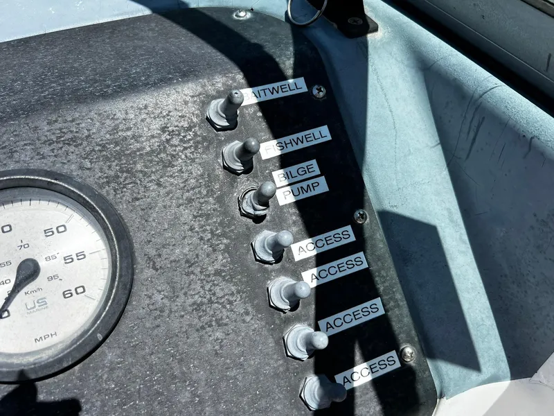 Slide: The Image of Control panel of a 1999 Bayliner Trophy boat with labeled switches and speedometer. - 19