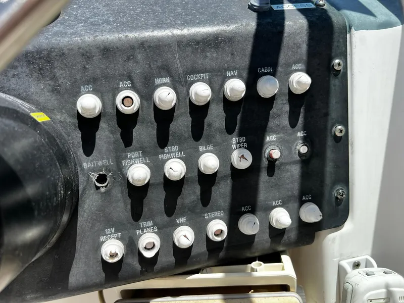 Slide: The Image of Control panel of a 1999 Bayliner Trophy boat with various switches and labels. - 20