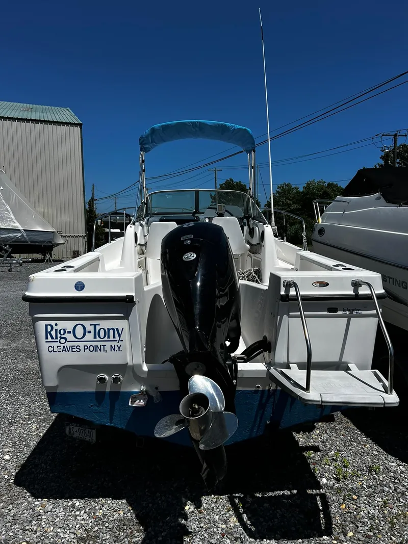 Slide: The Image of Bayliner 2002 Trophy boat, 1999 model, with outboard motor, parked on gravel. - 27