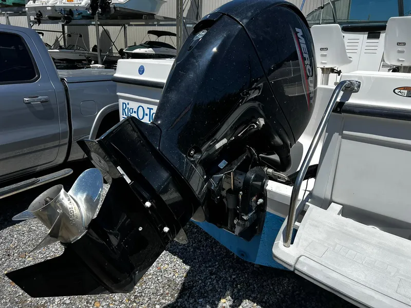 Slide: The Image of Outboard motor on a 1999 Bayliner Trophy boat, parked near a truck. - 5