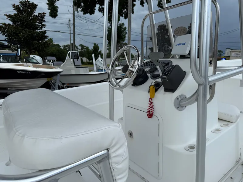 Slide: The Image of 2011 Carolina Skiff 218 DLV boat console with steering wheel and controls. - 15