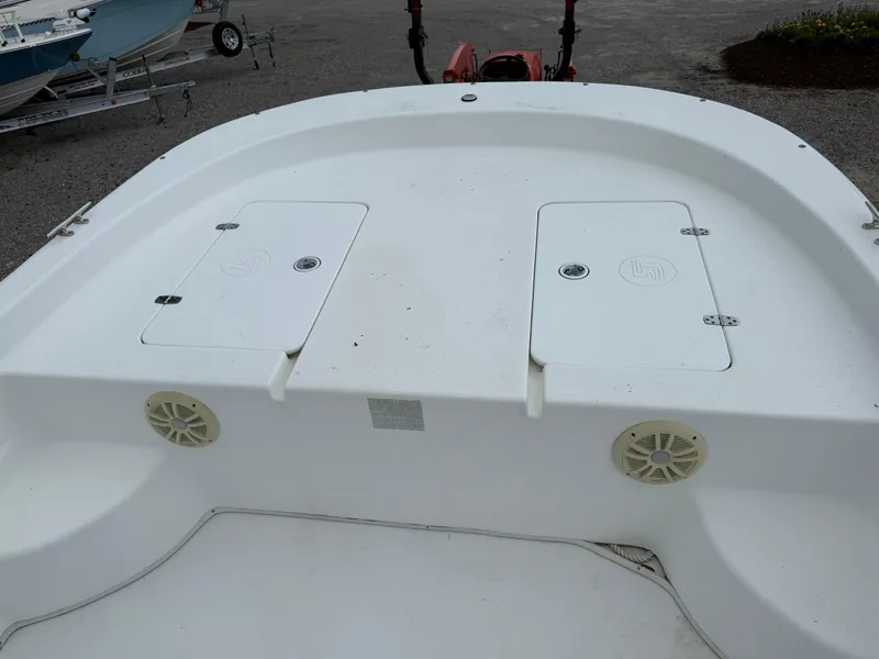 Slide: The Image of 2011 Carolina Skiff 218 DLV boat deck with storage compartments and speakers. - 17