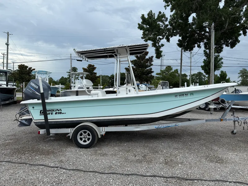 Slide: The Image of 2011 Carolina Skiff 218 DLV boat on trailer, parked outdoors. - 7