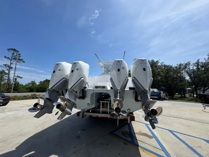 Slide: The Image of 2026 Invincible 38 Catamaran with four powerful outboard engines, parked outdoors. - 13