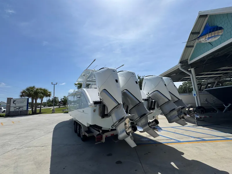 Slide: The Image of 2026 Invincible 38 Catamaran with quad outboard engines at a marina. - 15