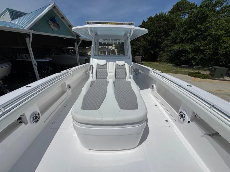 Slide: The Image of 2026 Invincible 38 Catamaran with sleek seating and modern design in a marina setting. - 20