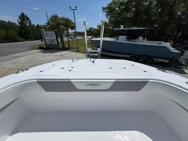 Slide: The Image of 2026 Invincible 38 Catamaran at a marina, showcasing sleek design and spacious deck. - 22