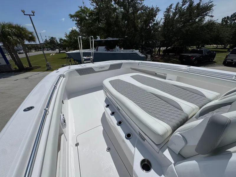 Slide: The Image of 2026 Invincible 38 Catamaran with sleek seating and modern design in a sunny outdoor setting. - 23