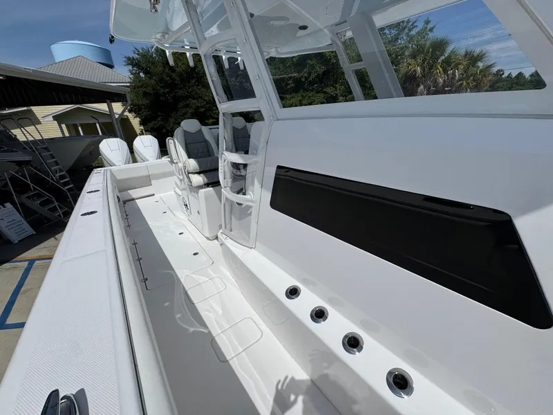 Slide: The Image of 2026 Invincible 38 Catamaran with sleek white interior and modern seating. - 25