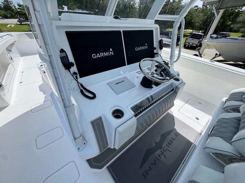 Slide: The Image of 2026 Invincible 38 Catamaran helm with Garmin displays and steering wheel. - 28