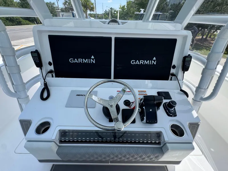 Slide: The Image of Helm of 2026 Invincible 38 Catamaran with Garmin displays and Mercury controls. - 29