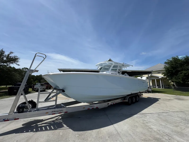 Slide: The Image of 2026 Invincible 38 Catamaran on trailer, parked outdoors under clear blue sky. - 3