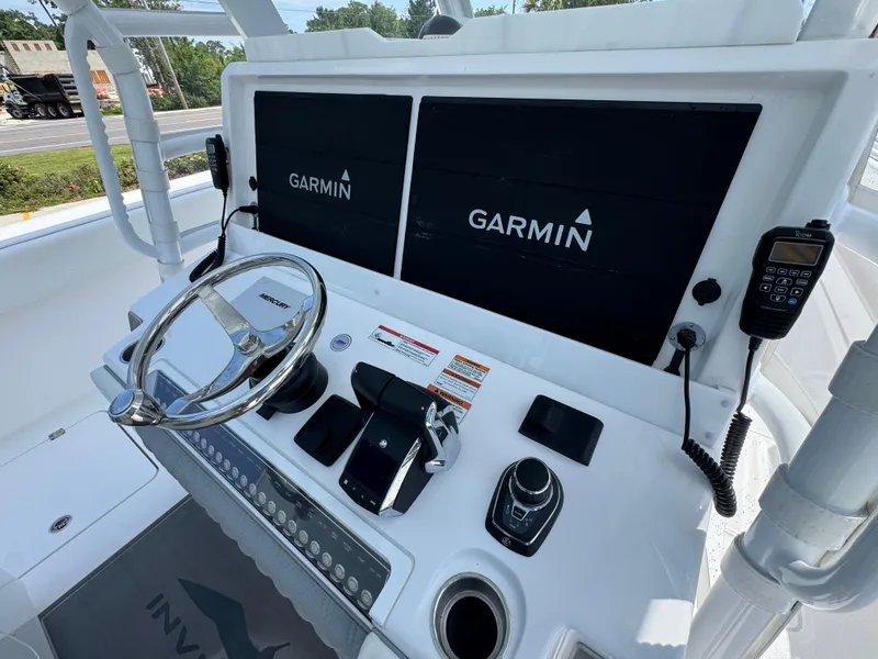 Slide: The Image of 2026 Invincible 38 Catamaran helm with Garmin displays and Mercury steering wheel. - 31