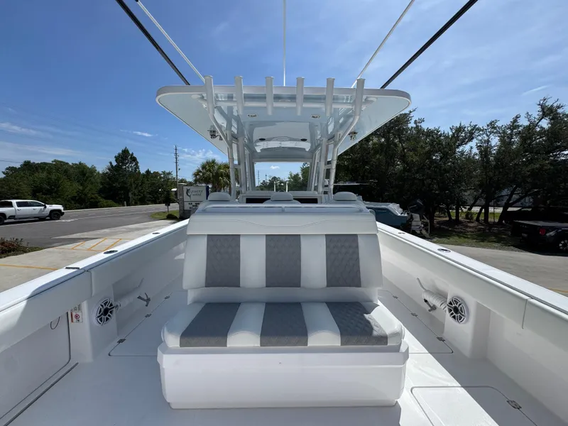 Slide: The Image of 2026 Invincible 38 Catamaran with sleek seating and modern design under a clear blue sky. - 33